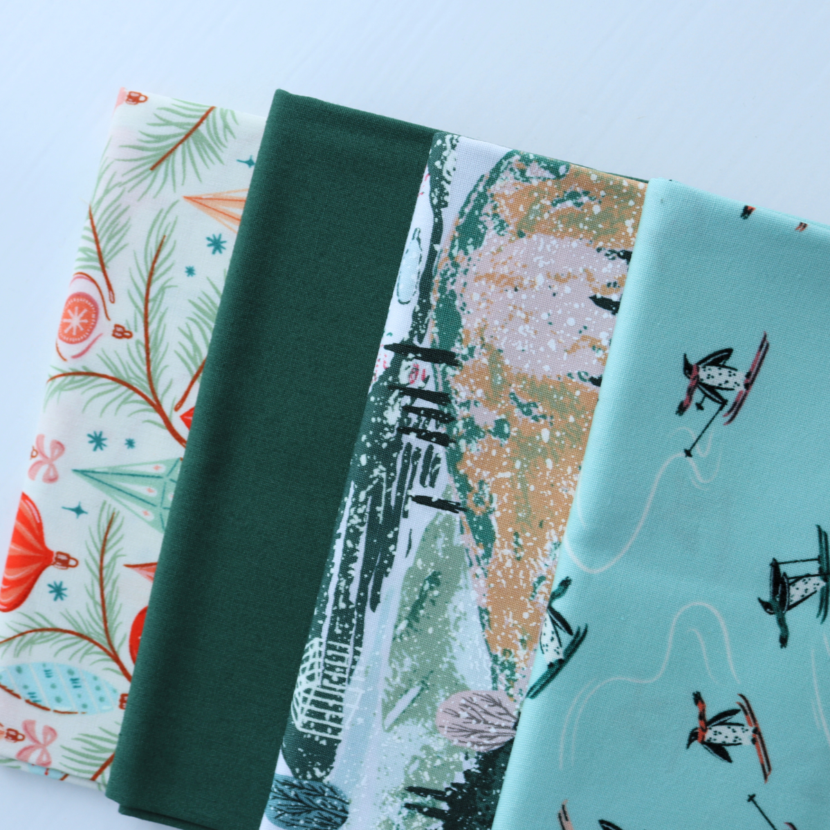 Four fabric swatches with different patterns on a light blue background