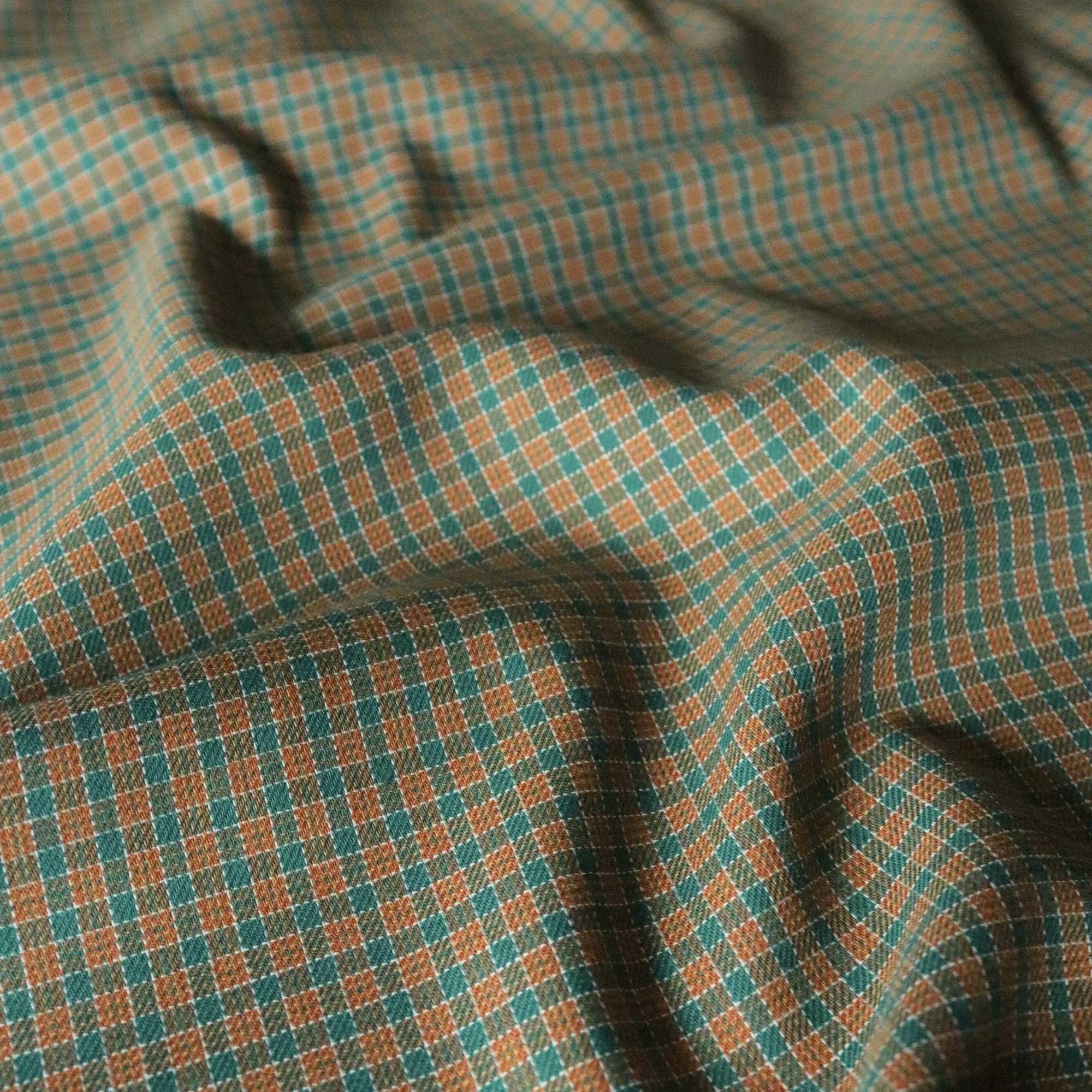 Close-up of checkered fabric with green and brown pattern