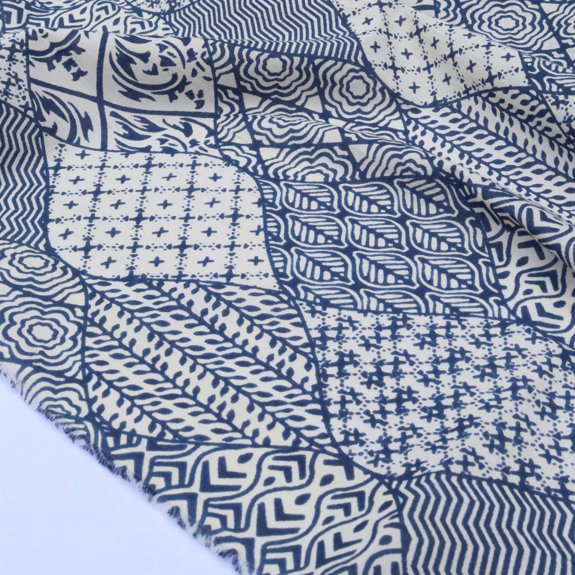 Blue and white patterned fabric with various geometric designs.