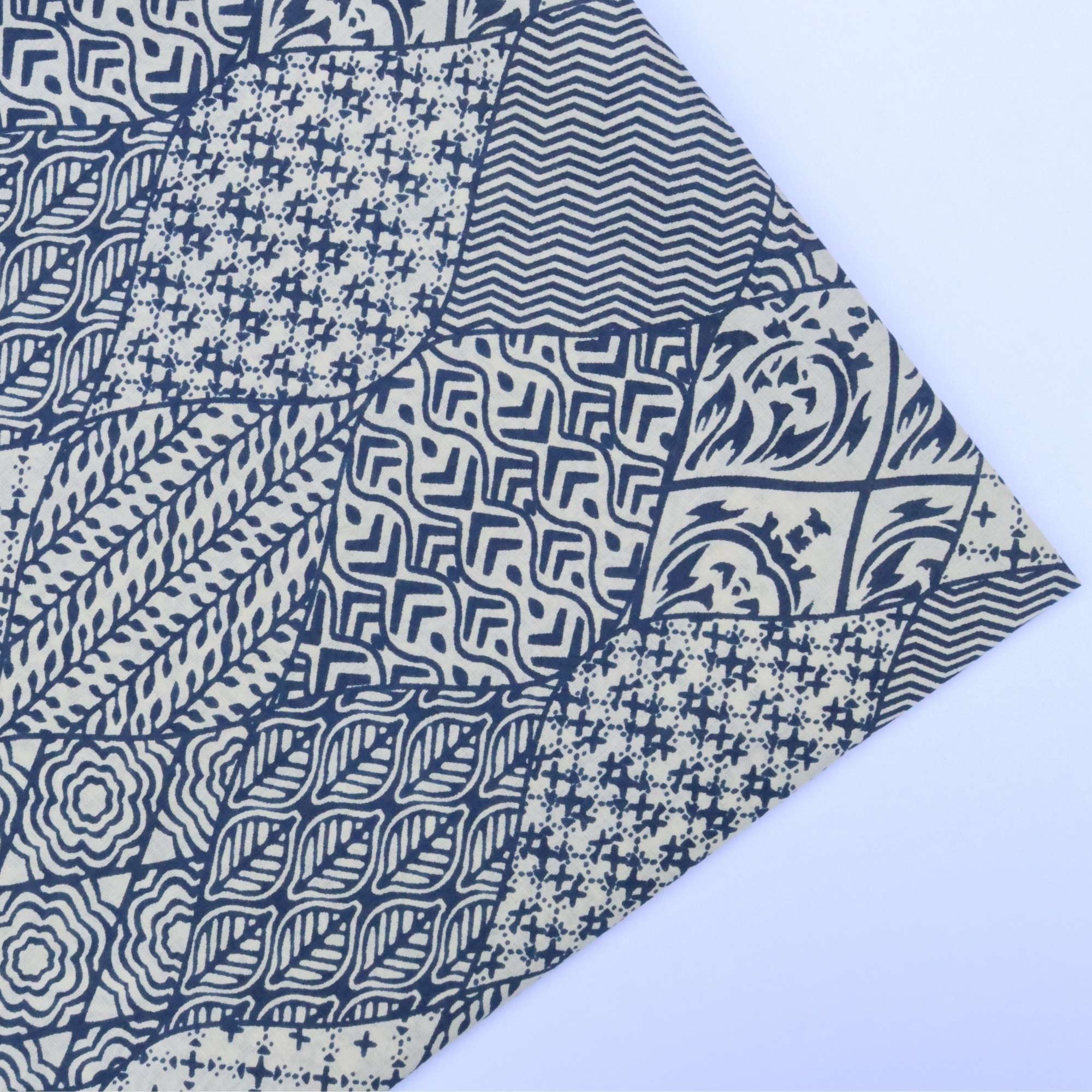Collection of blue and white patterned fabric swatches on a light blue background