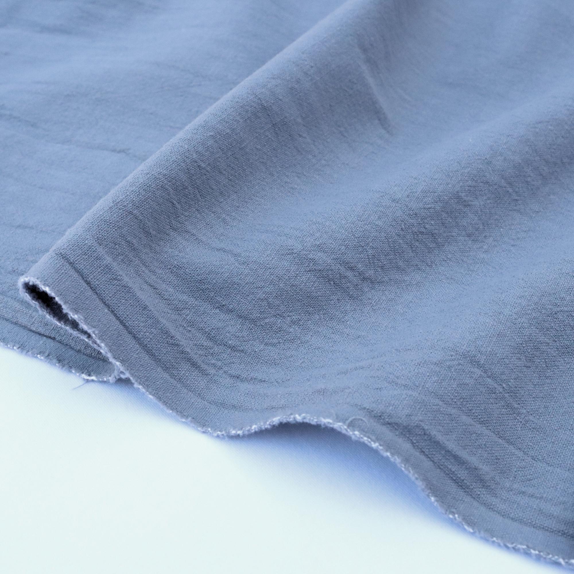 Close-up of blue fabric with a textured surface on a white background