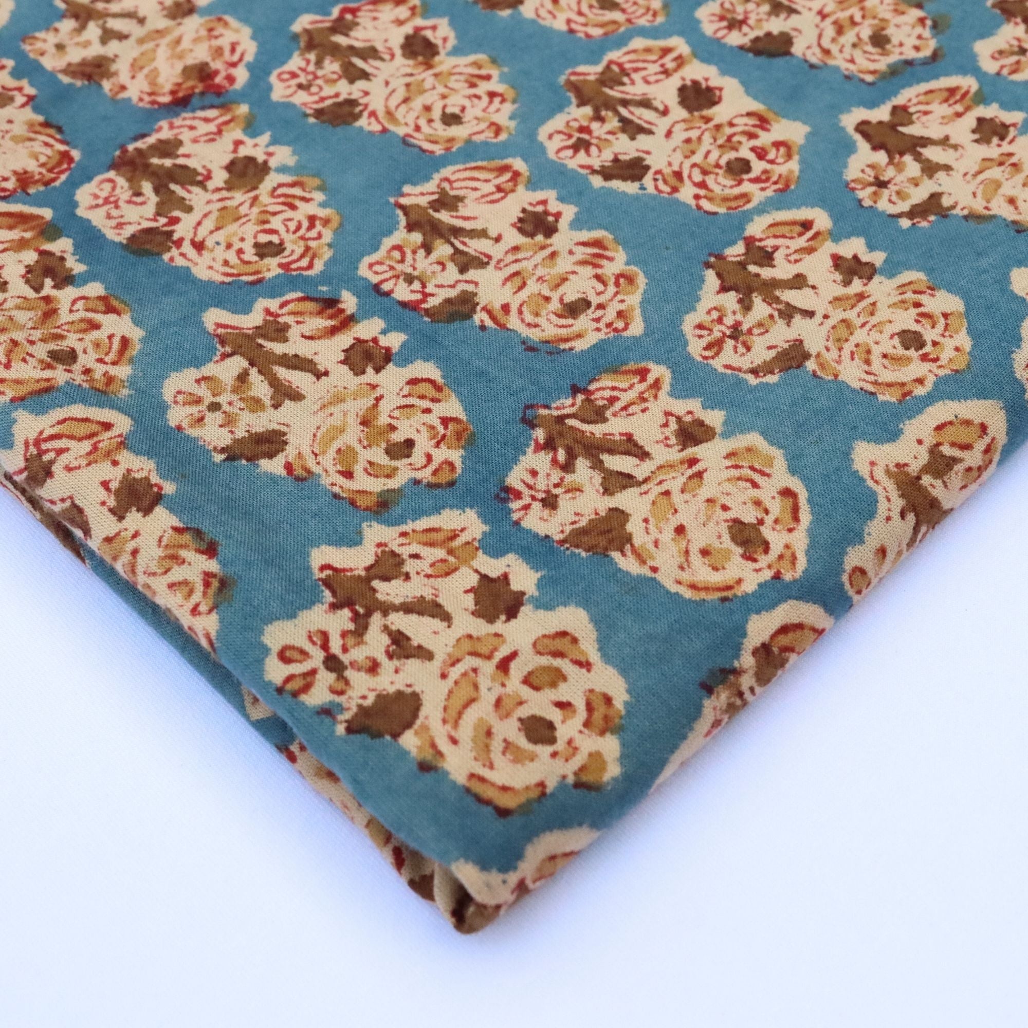 Floral patterned fabric with beige flowers on a blue background