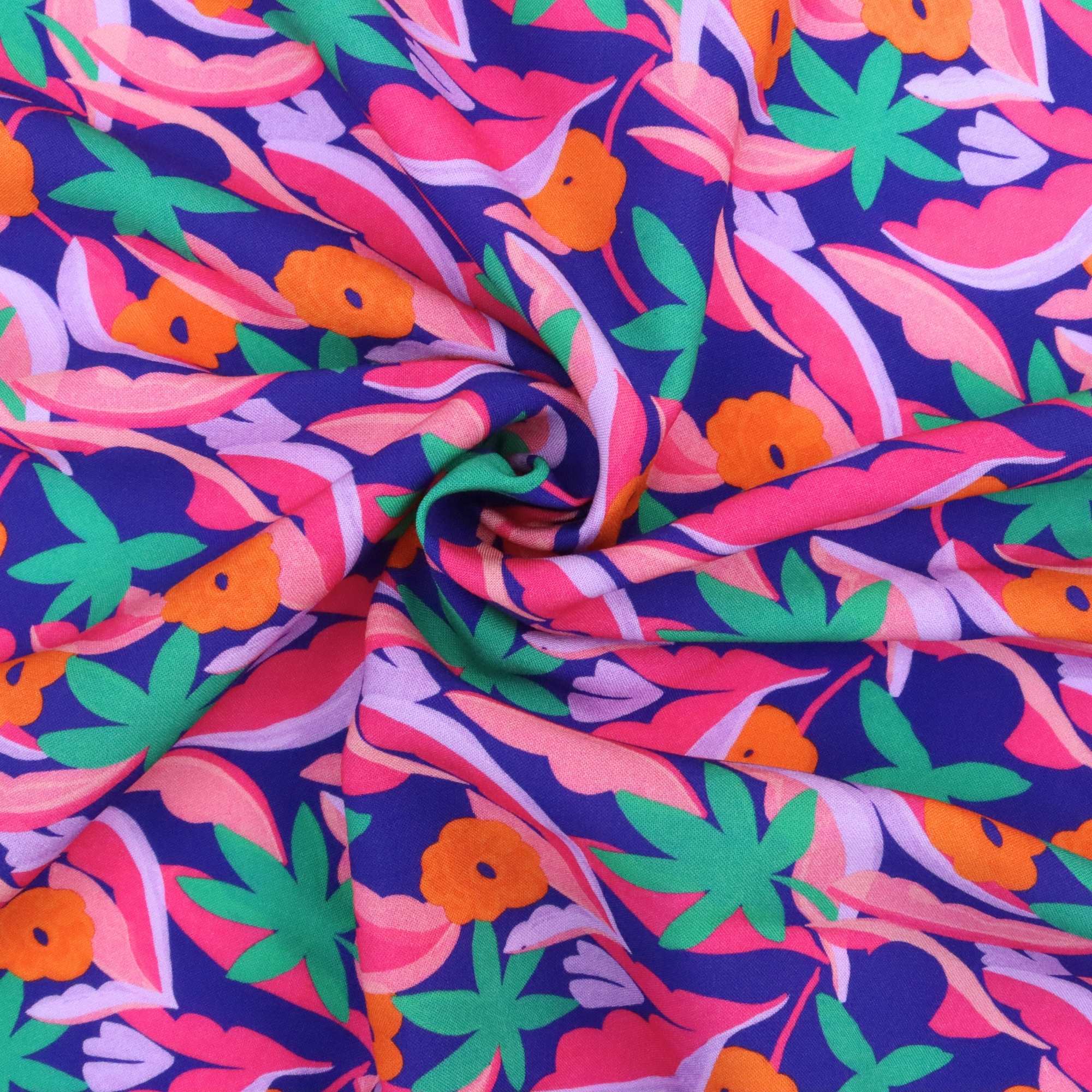 Colorful fabric with a tropical pattern featuring leaves and flowers on a blue background.