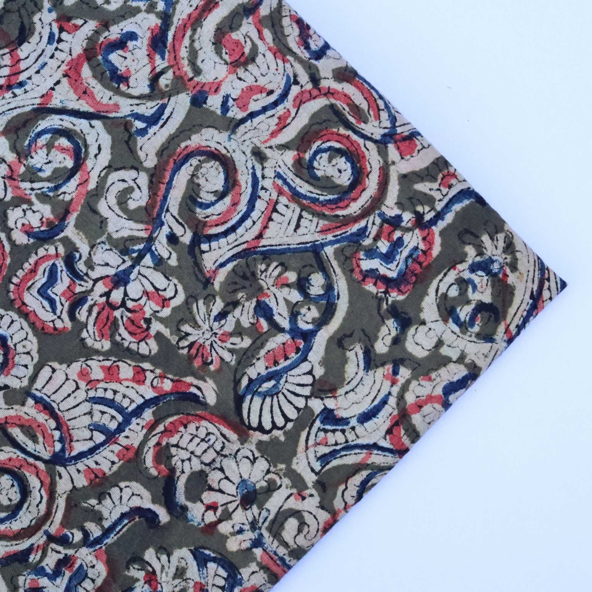 Fabric with intricate paisley pattern on a white background