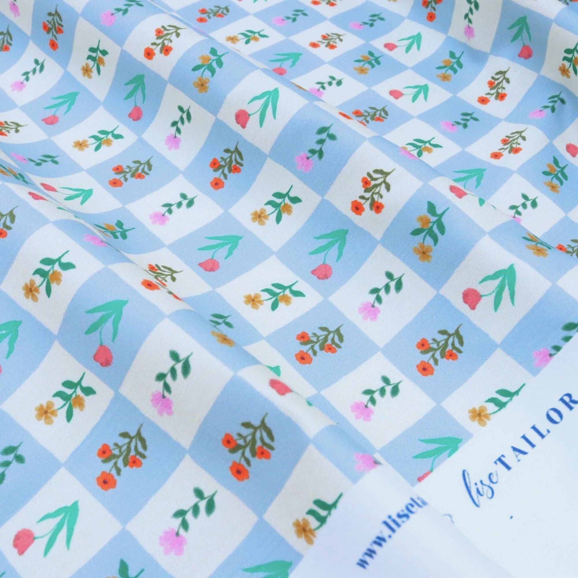 Floral patterned fabric with a checkered background and &