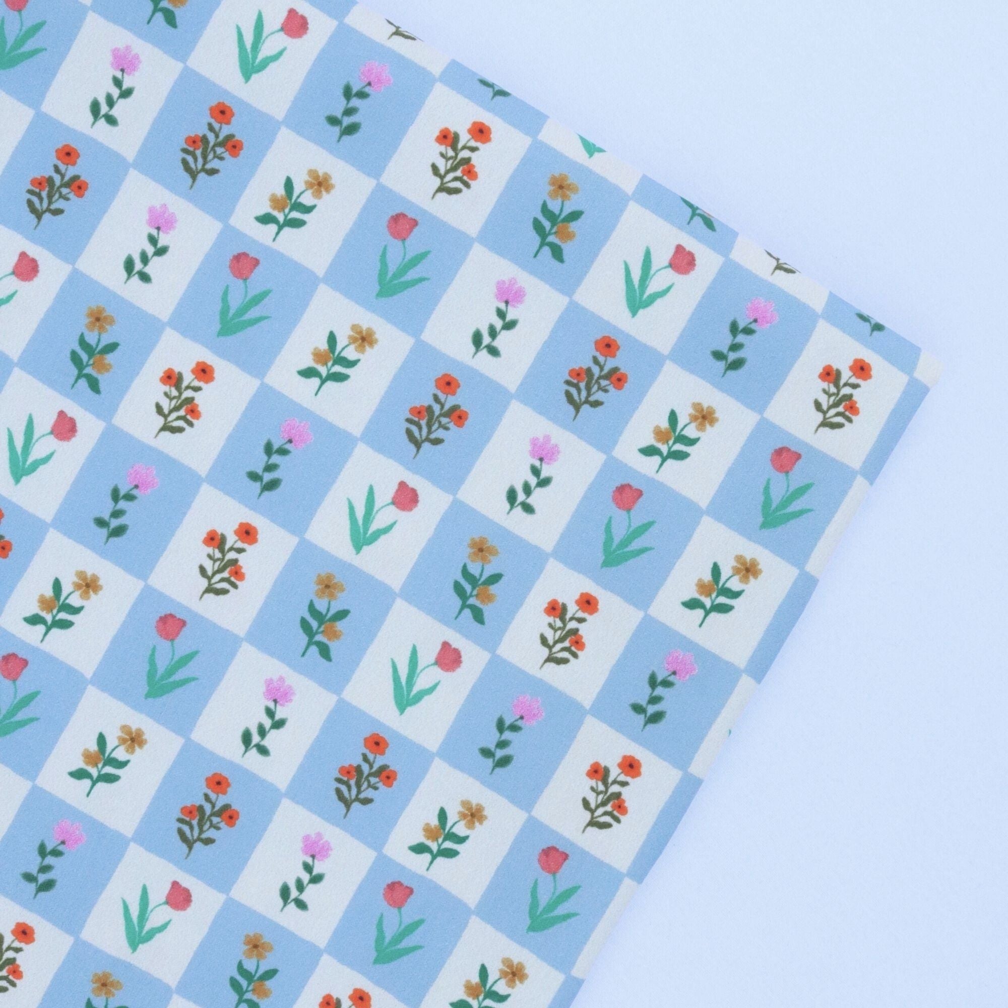 Floral patterned paper with a blue checkered background