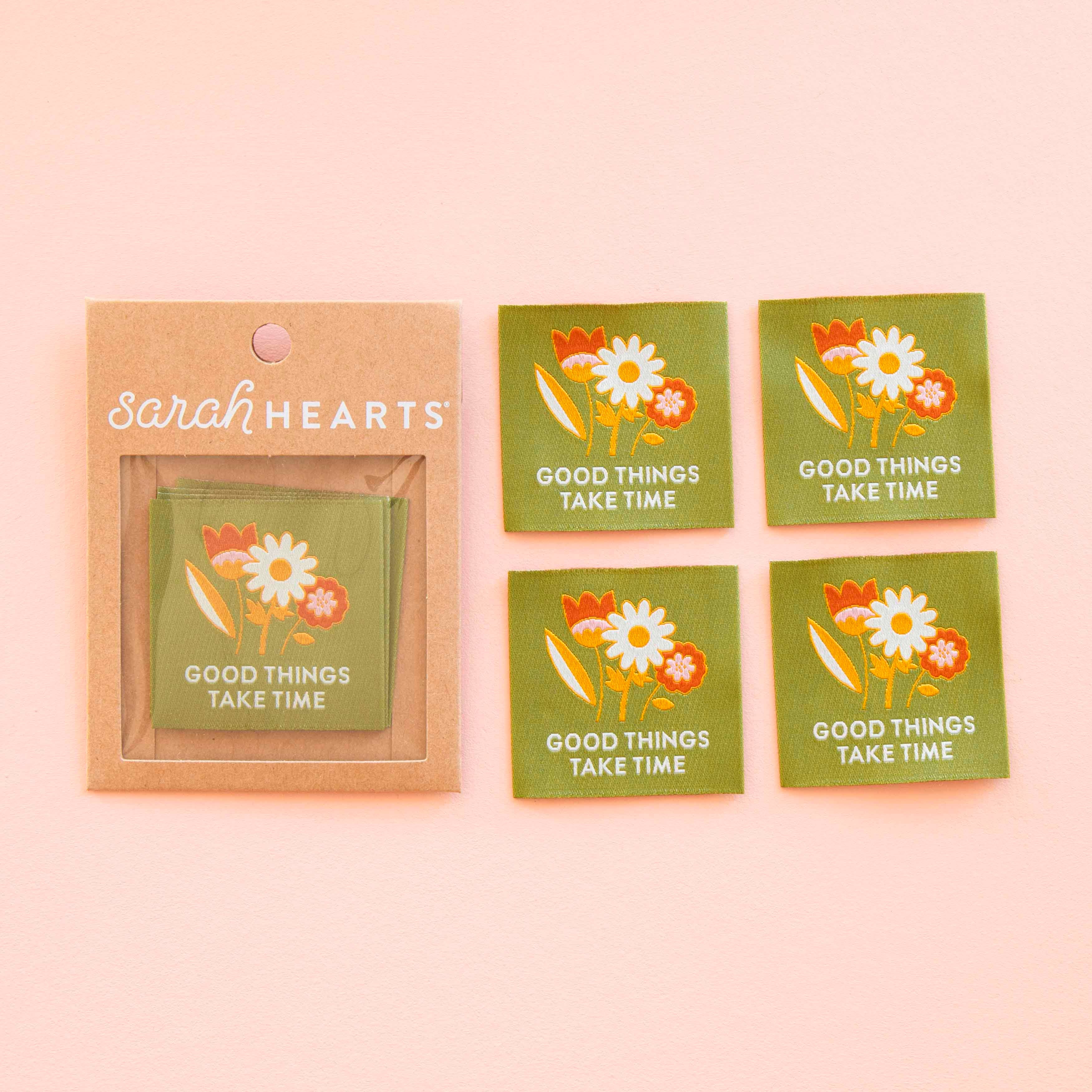 "Good Things Take Time" Sewing Label for your garments. Woven Labels laid out, floral design with the words "Good Things Take Time" on a Green background.