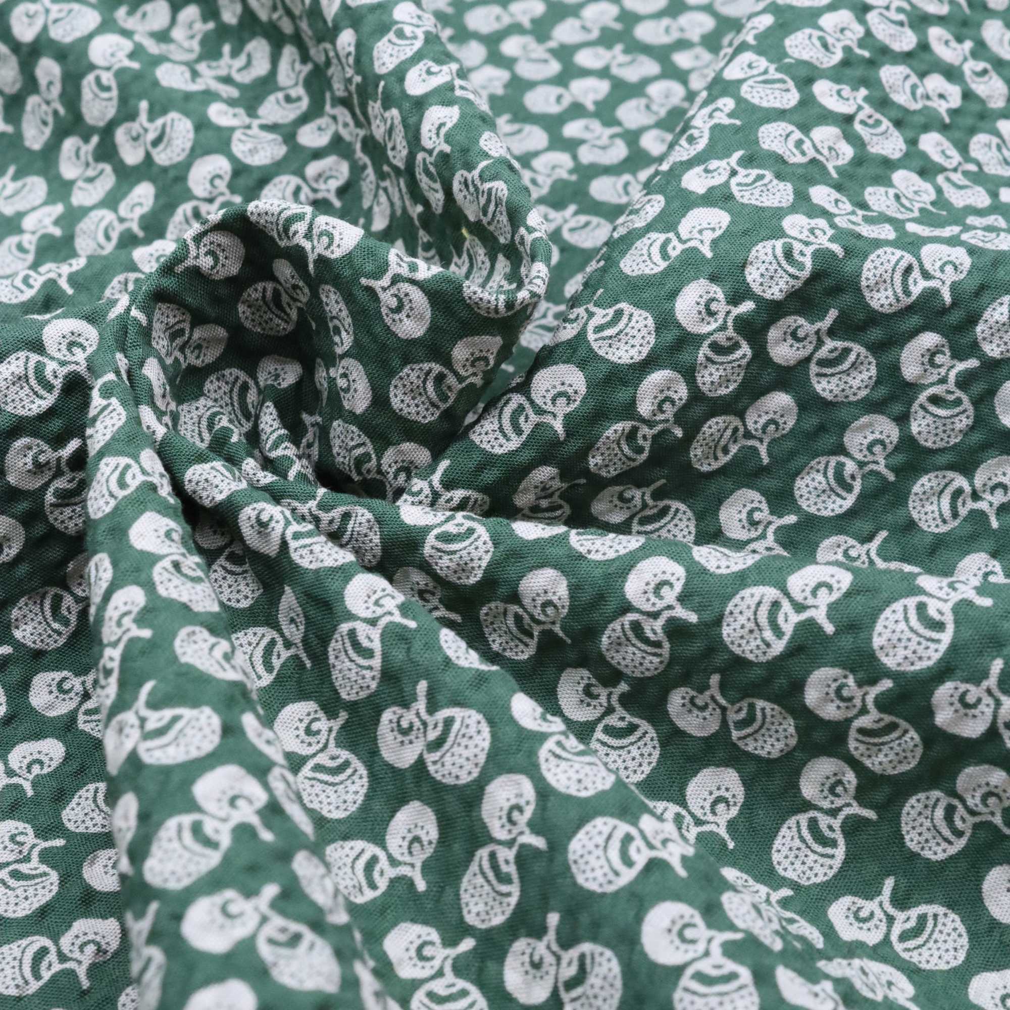 Green fabric with white pattern of small shapes