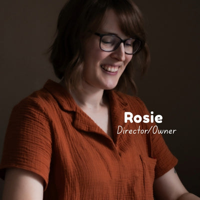 Woman wearing a rusty double gauze fabric top, smiling and looking down