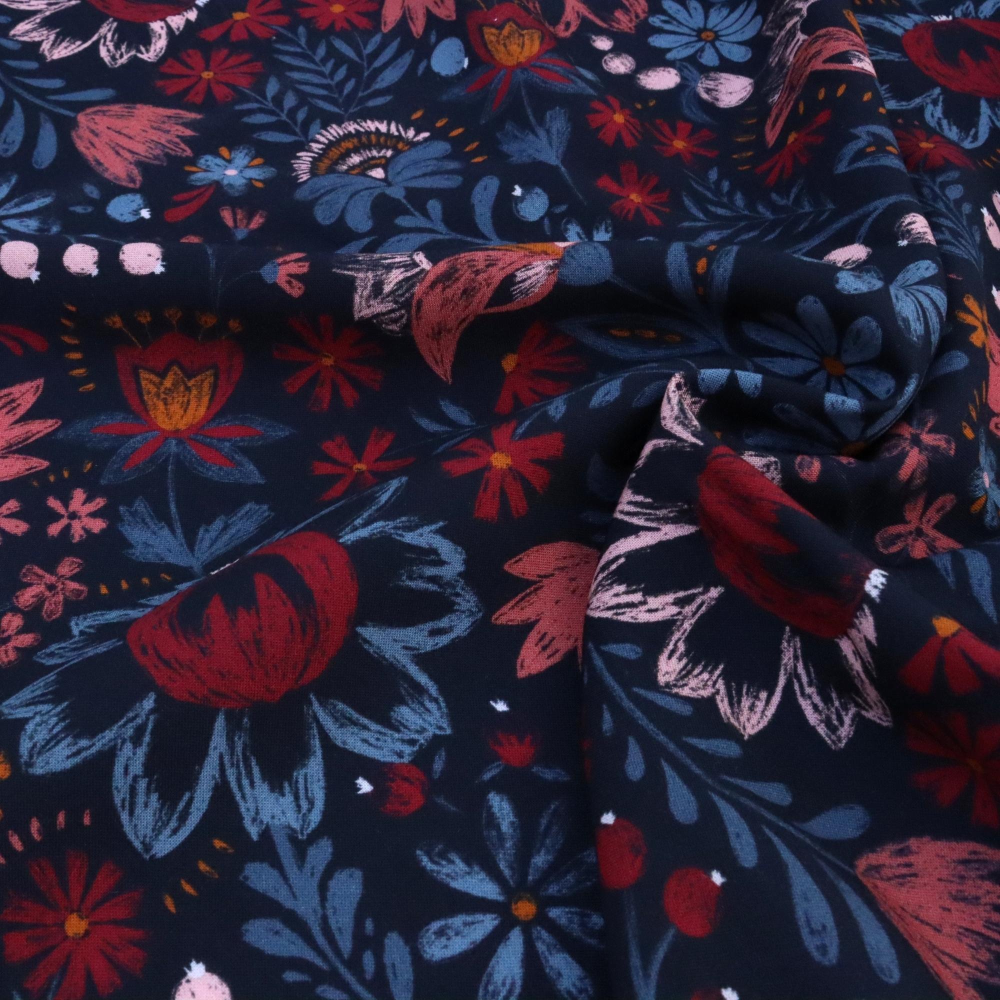 Floral fabric pattern with red, blue, and pink colors on a dark background