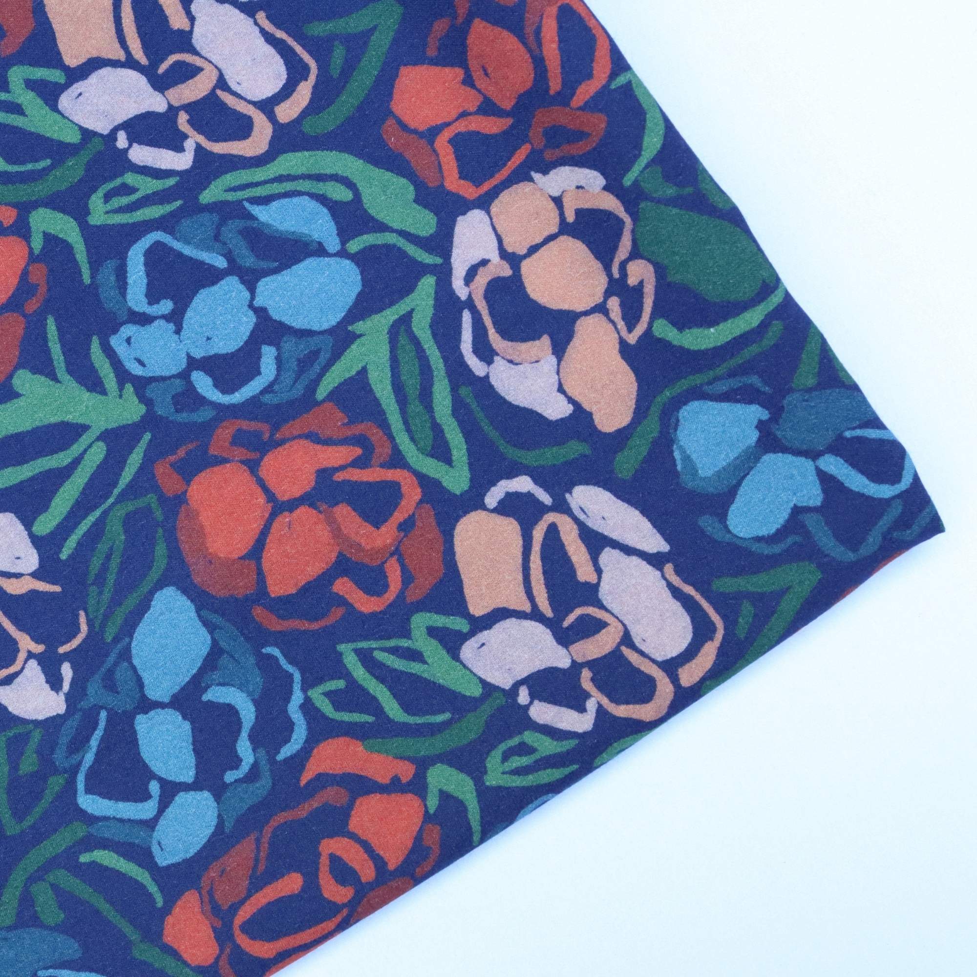 Floral patterned fabric with colourful flowers on a blue background