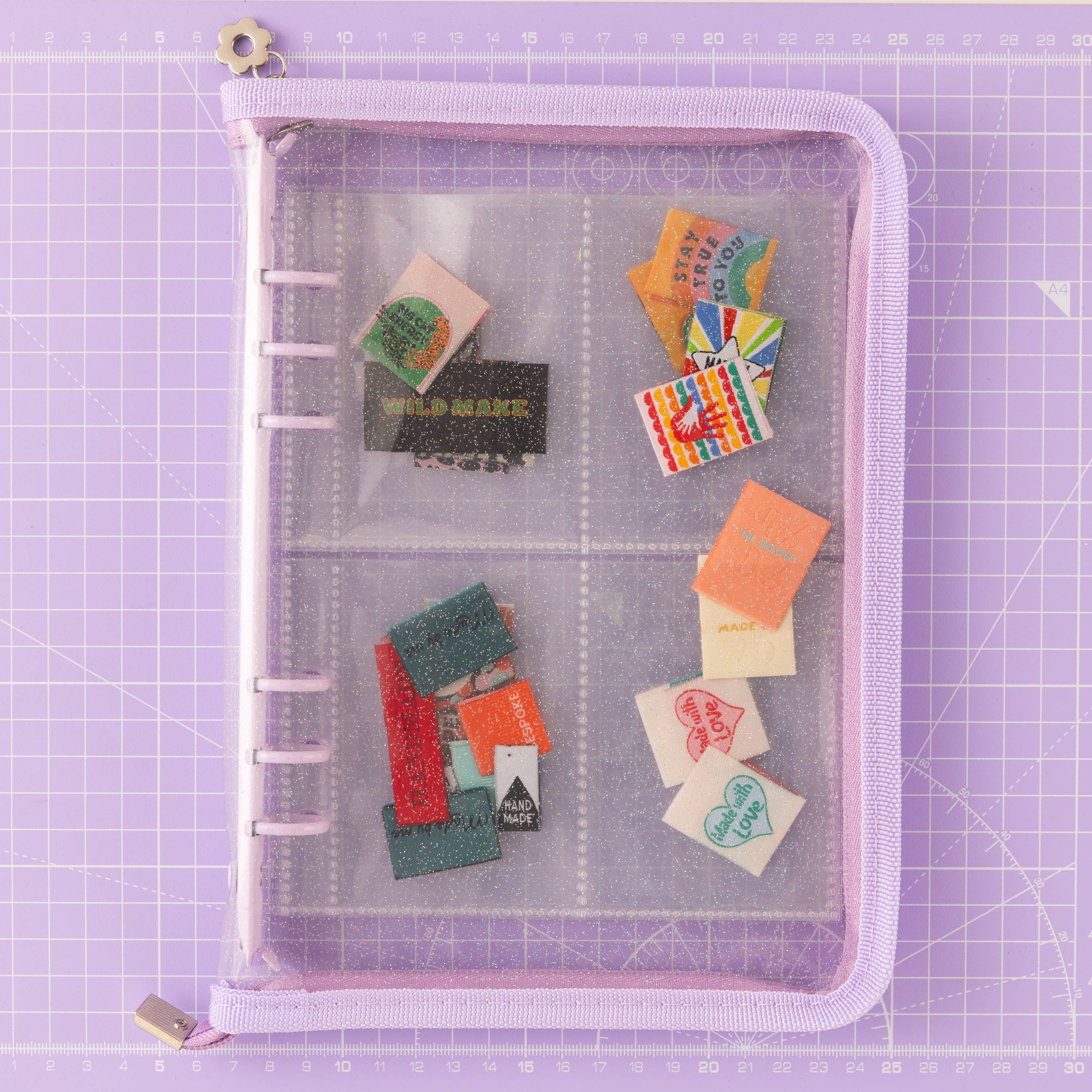 Collection of sew in woven labels in a transparent purple folder. Perfect for storing your sewing labels.