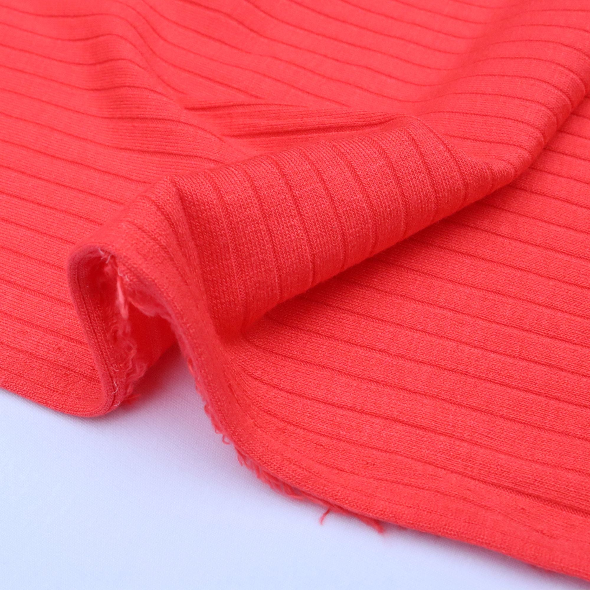Close-up of red ribbed fabric on a white background