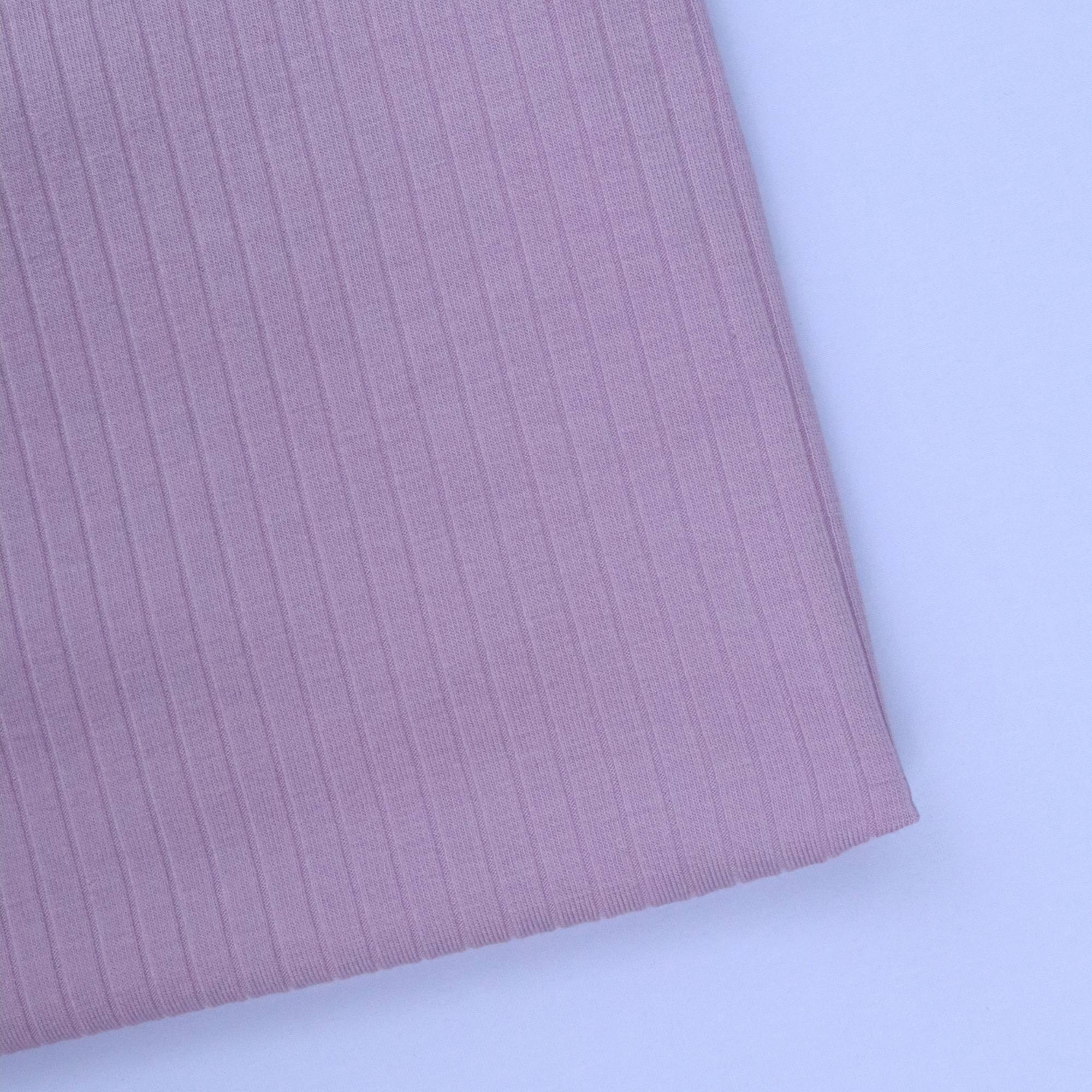 Close-up of pink ribbed fabric on a white background