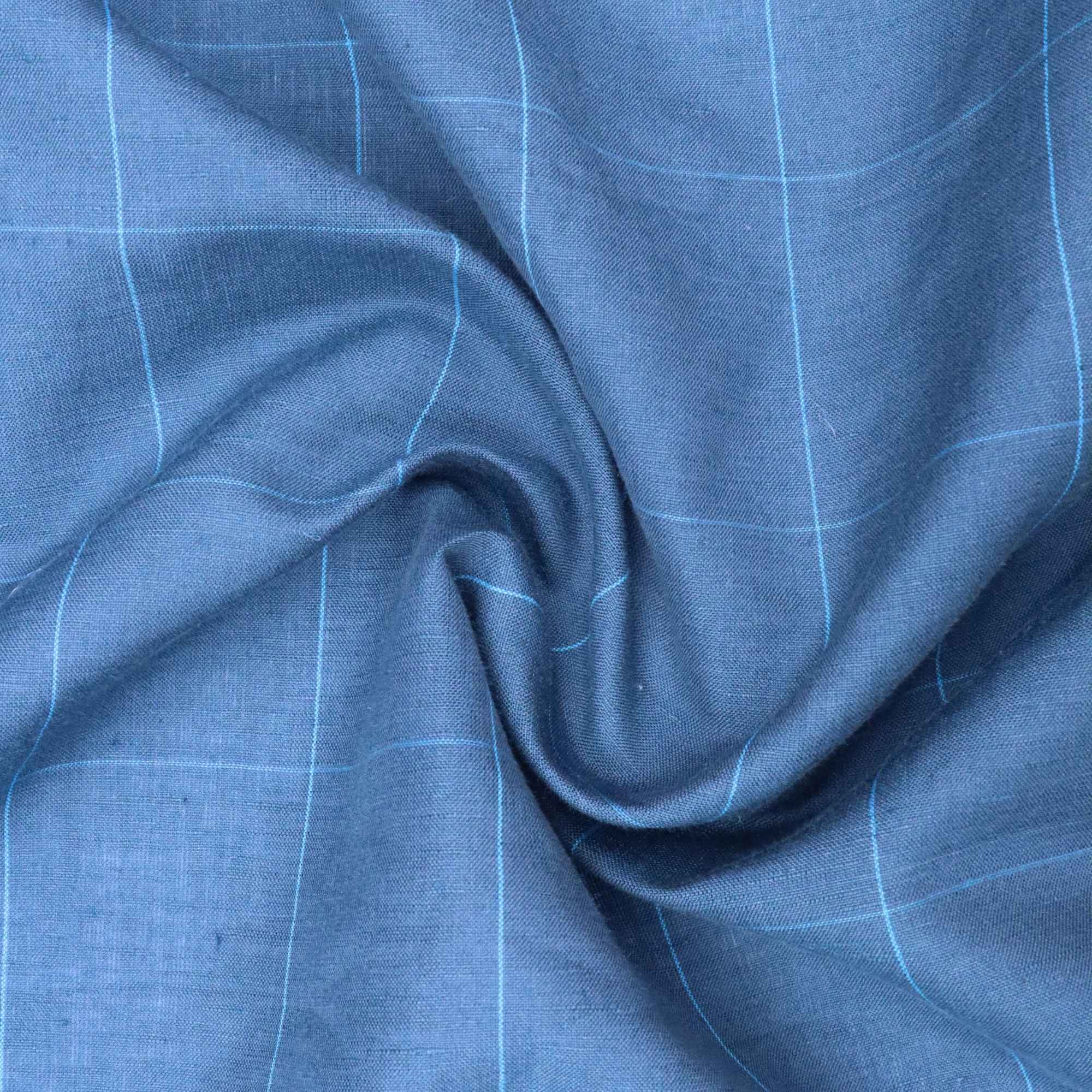 Close-up of blue fabric with a subtle check pattern