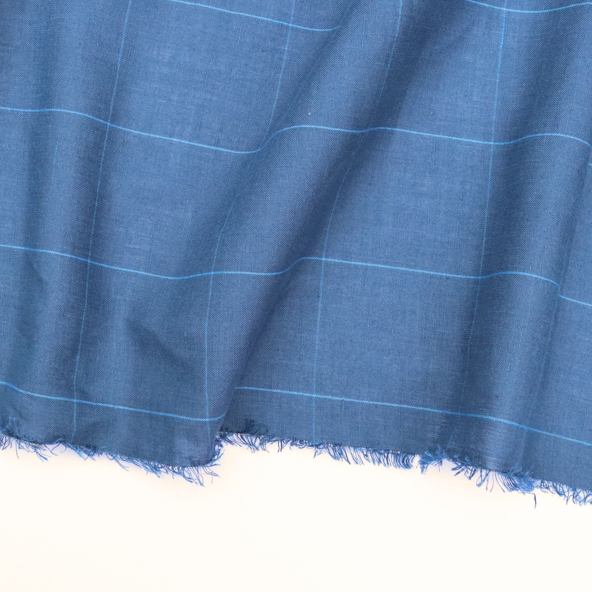 Blue fabric with a check pattern on a white background