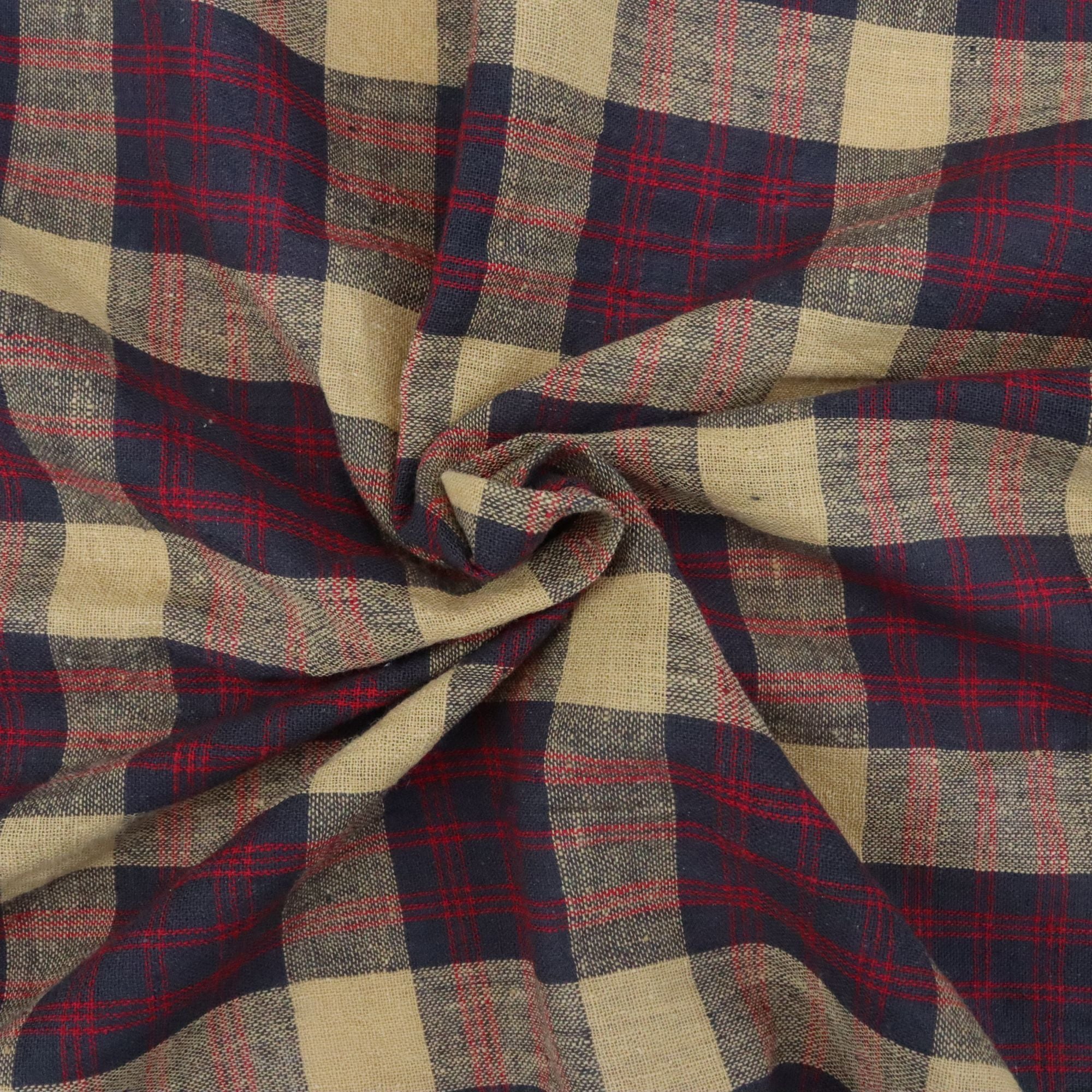 Close-up of plaid fabric with red, blue, and beige colors.