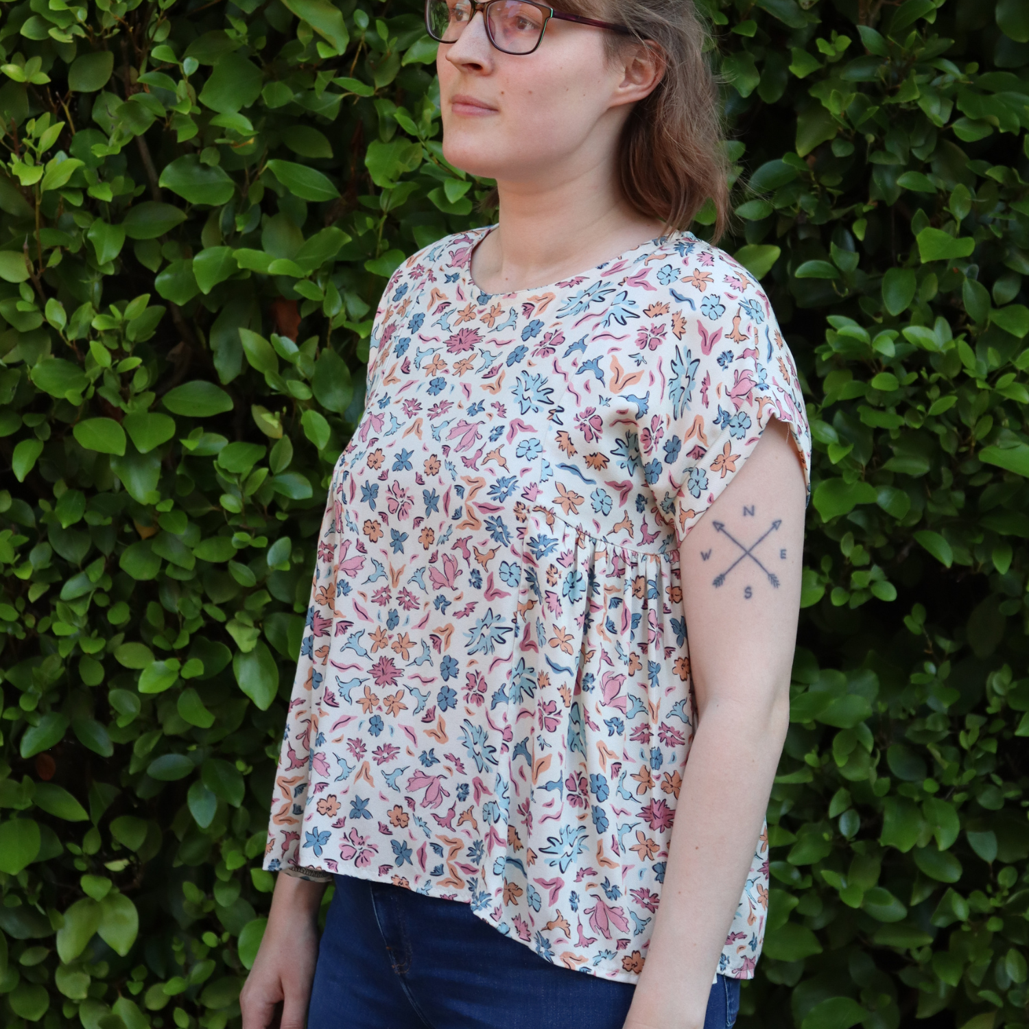 White Woman wearing Blue Fabric with floral patterns. Sewing Pattern is the Collage Gather Top and it's part of the Sewing Project Kits from Sew Eco Fabrics