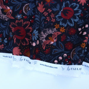 Floral fabric with red and blue colors and a visible brand label.