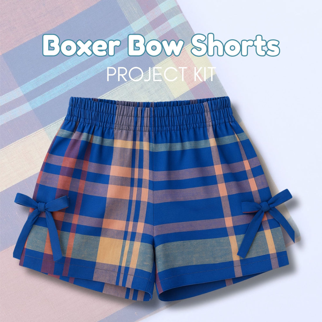 Plaid shorts with bow details on a colorful geometric background, labeled &