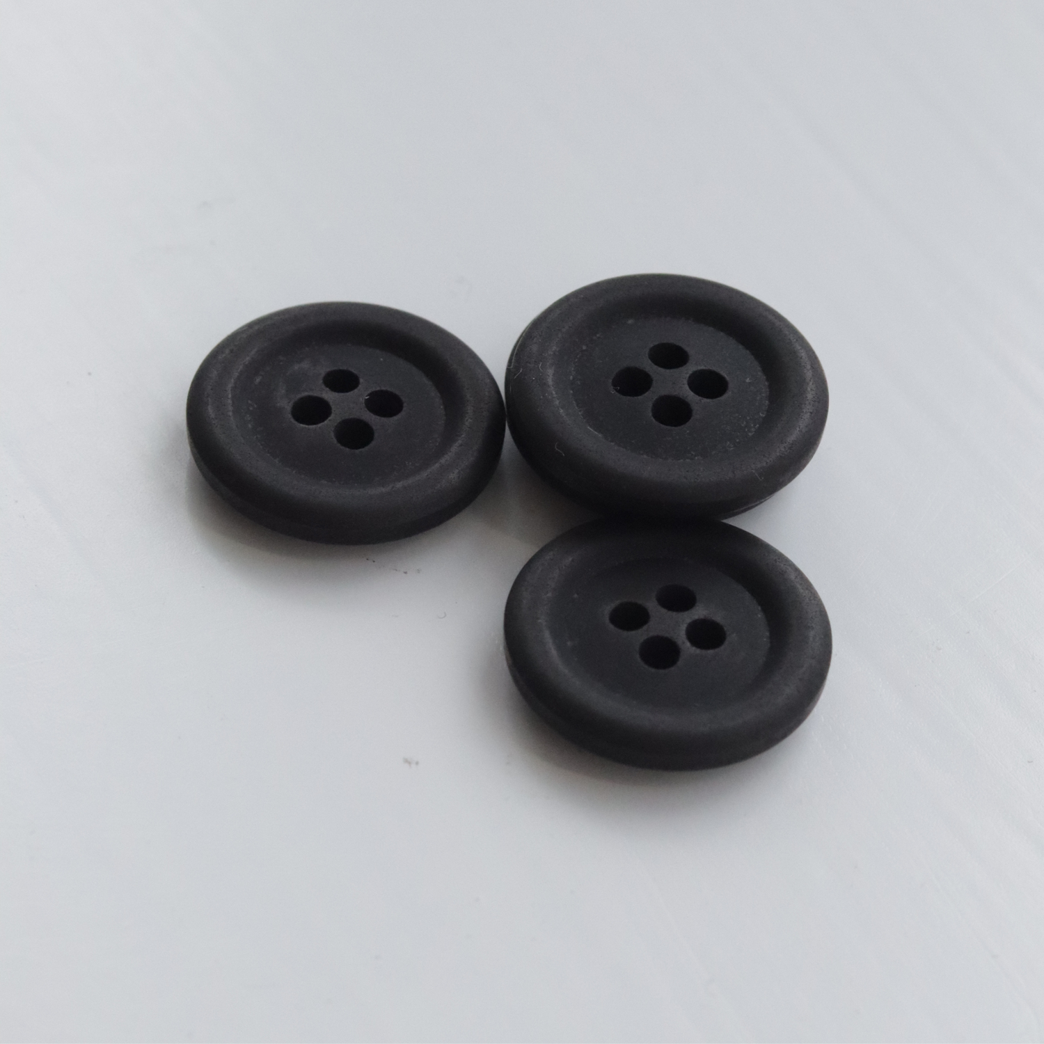 Three black buttons on a white background