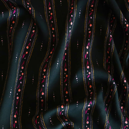 Black viscose fabric with hand-drawn vertical stripes and dotted pink, coral, and mustard motifs, perfect for flowing garments like dresses and skirts.