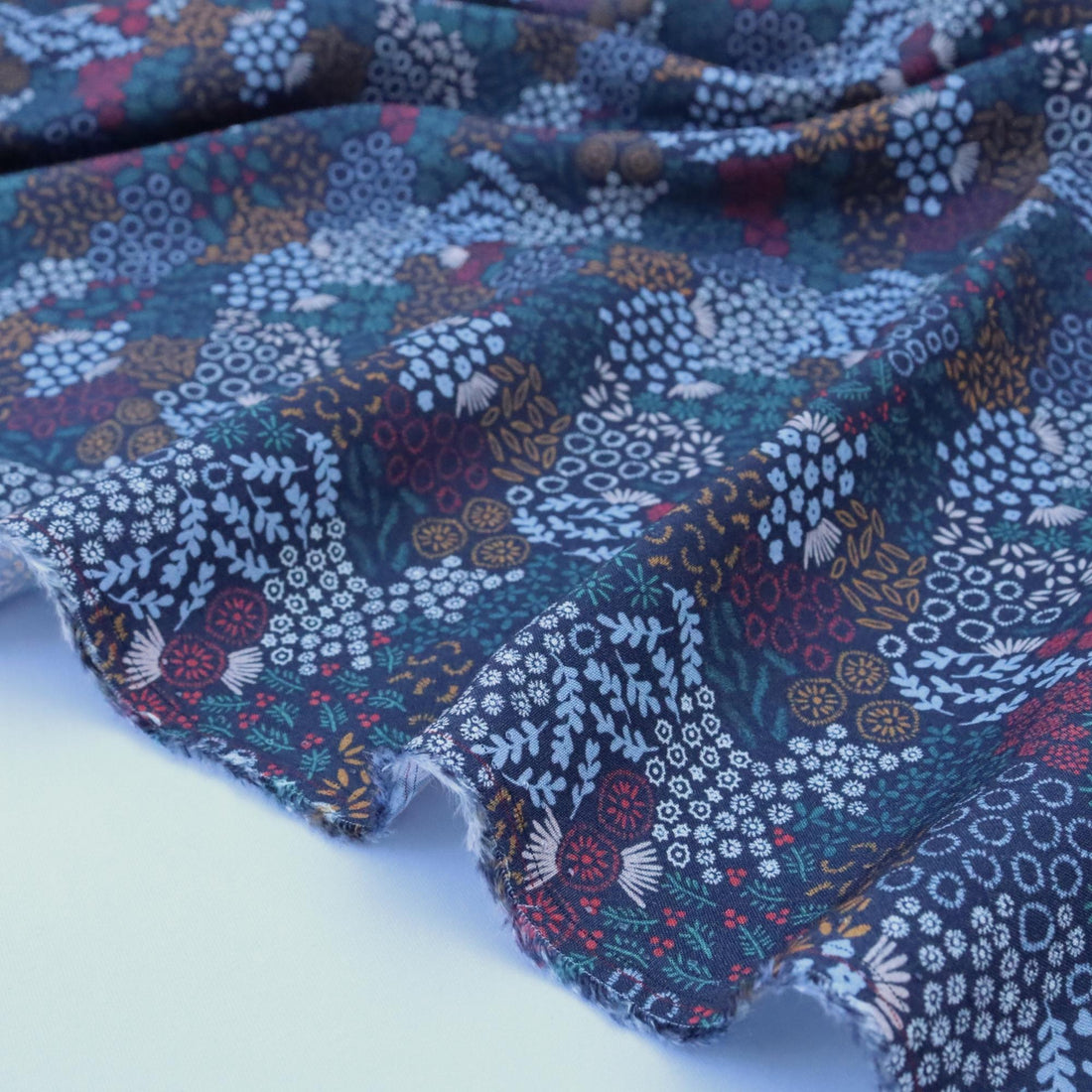 Multicolored floral patterned fabric on a white background