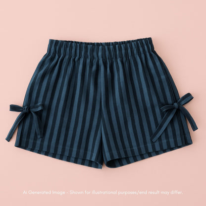 Navy striped shorts with ties on a pink background