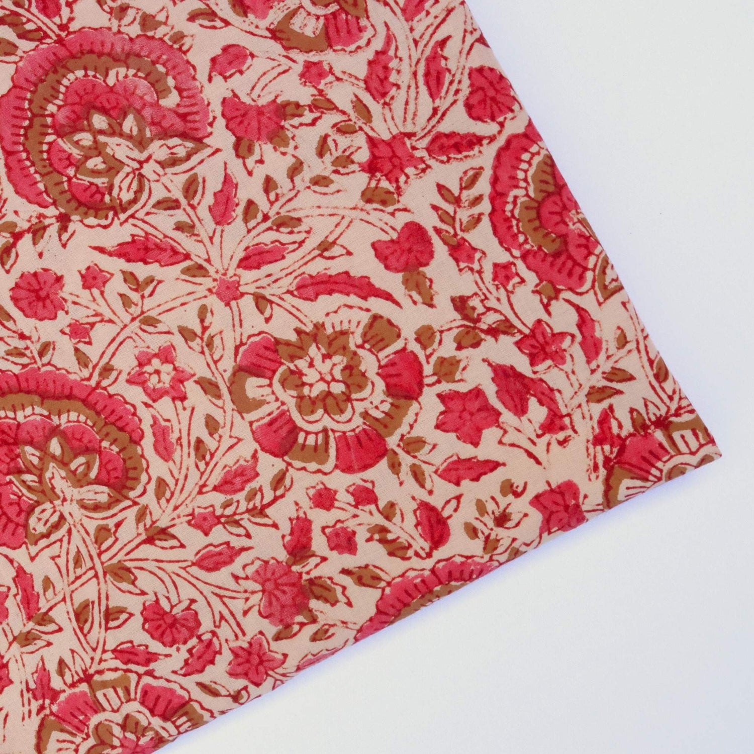 Close-up of a pink and brown floral patterned fabric on a white background