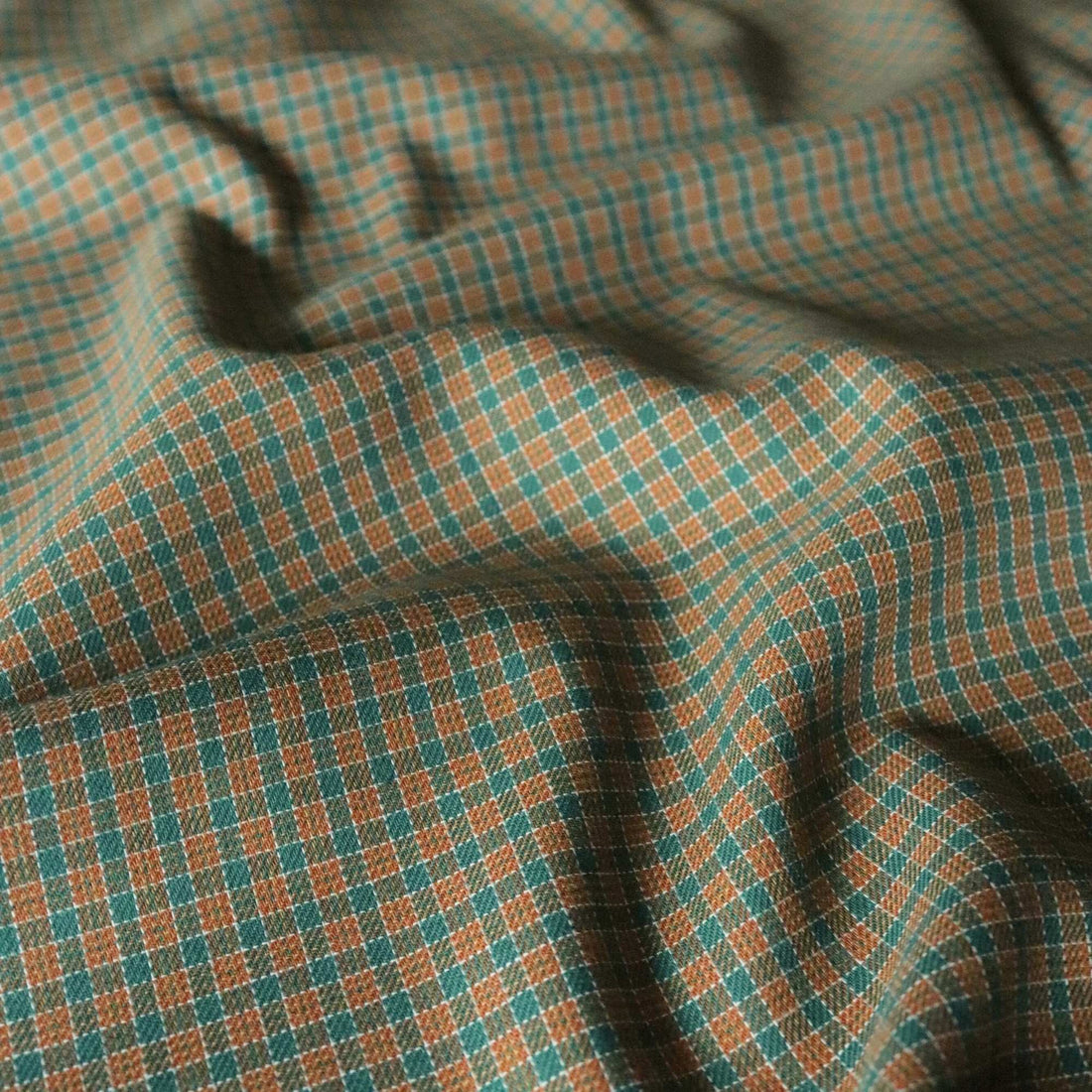 Close-up of checkered fabric with green and brown pattern