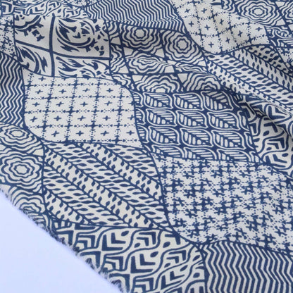 Blue and white patterned fabric with various geometric designs.