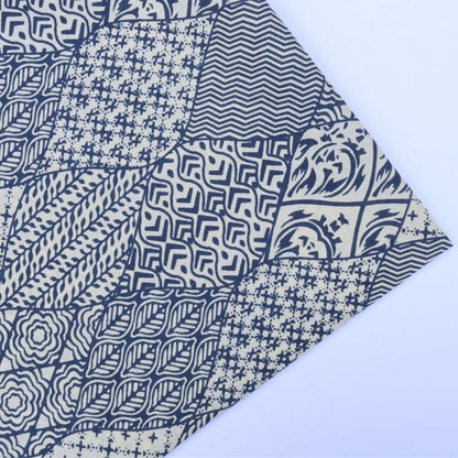 Collection of blue and white patterned fabric swatches on a light blue background