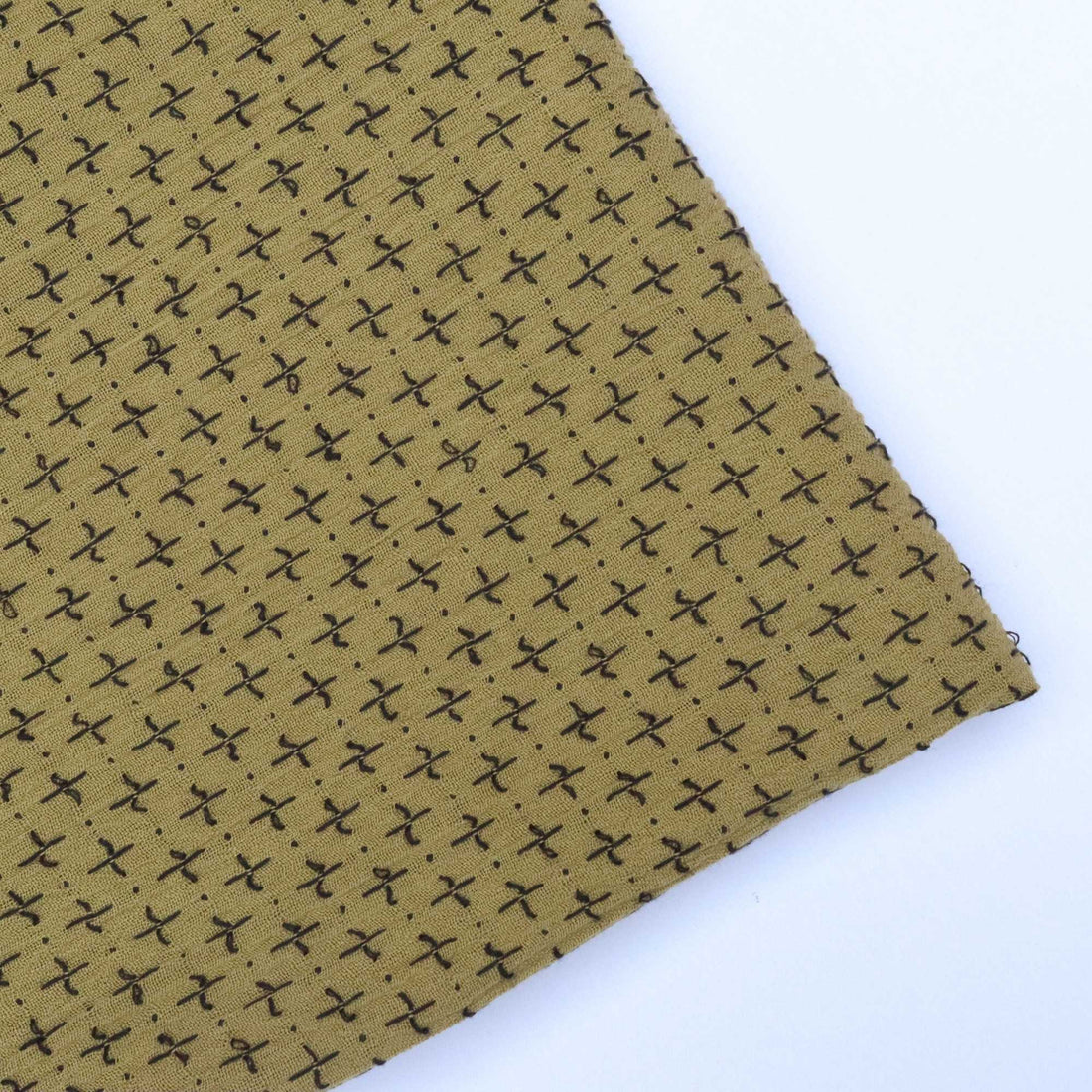 Brown fabric with black geometric pattern on a white background