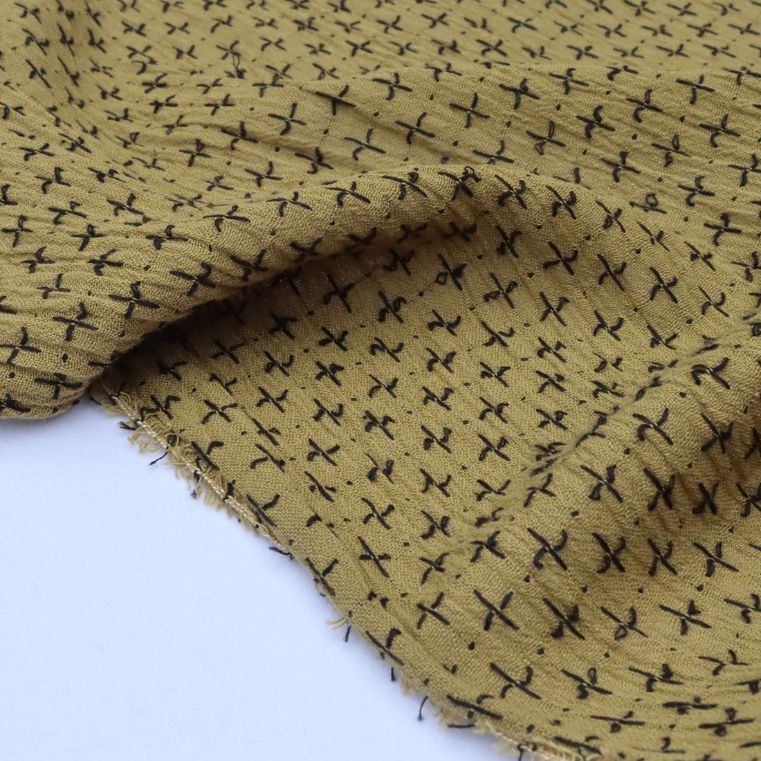 Yellow fabric with black geometric pattern on a white background