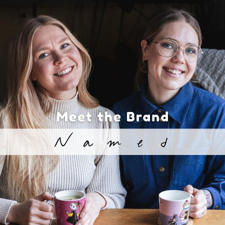 Two women sitting together with mugs, text overlay 'Meet the Brand Named', brand name 'Named' visible