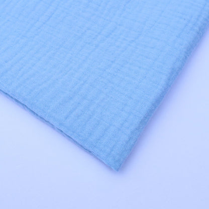 Close-up of light blue textured fabric on a matching background
