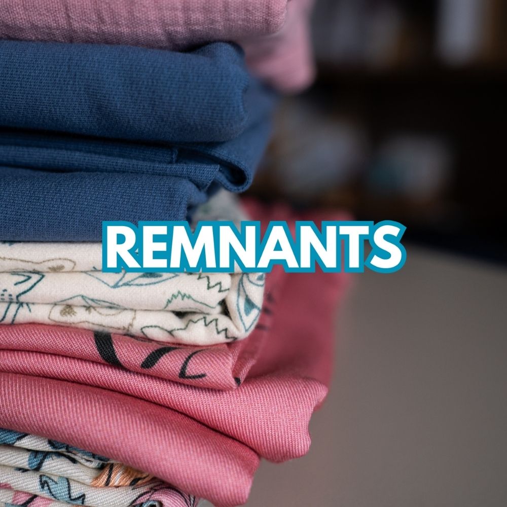 Stack of remnant fabrics in blue, pink and printed designs – shop fabric offcuts at Sew Eco Fabrics