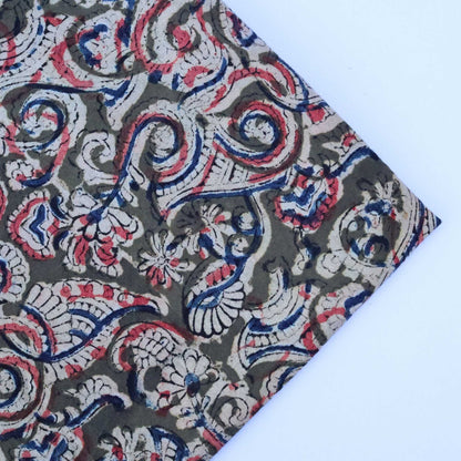Fabric with intricate paisley pattern on a white background