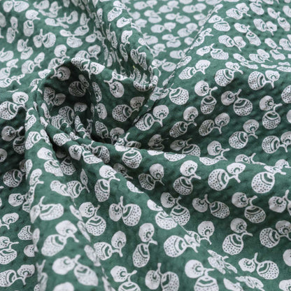 Green fabric with white pattern of small shapes