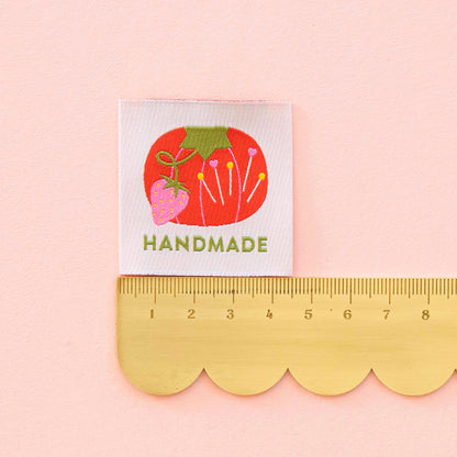 Sewing Label saying &quot;Handmade&quot; with a tomato pin cushion design on white background. Measured with a ruler 4.5cm.
