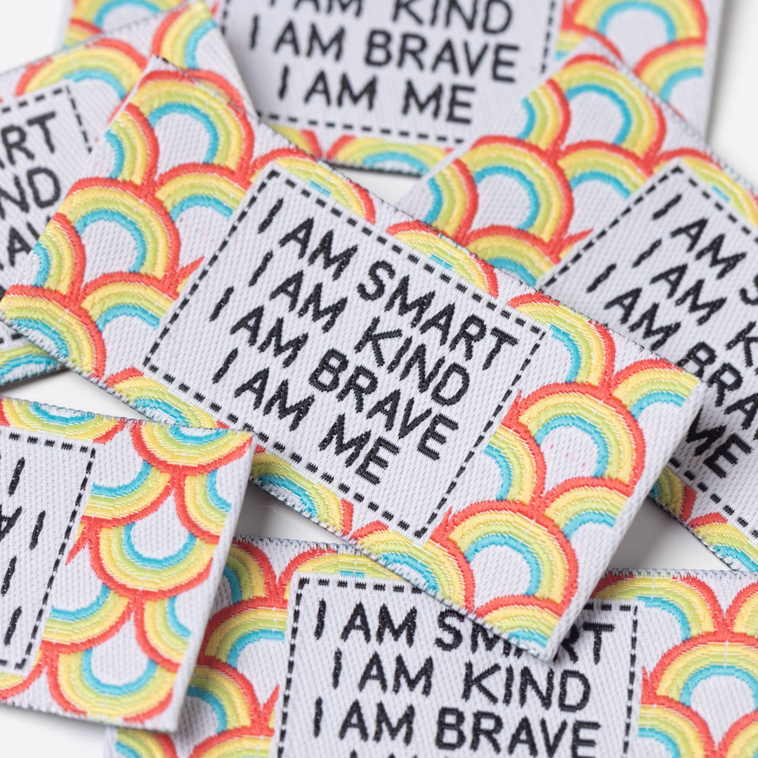 Motivational Sew in Labels with affirmations on rainbow, multicoloured background.