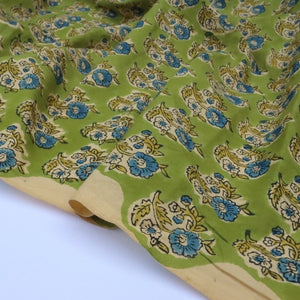 Green fabric with floral pattern on a white background