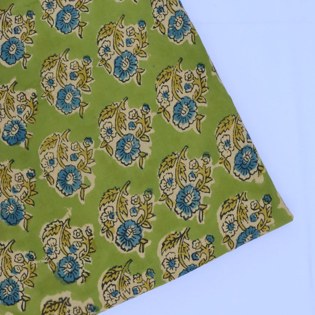 Floral patterned fabric on a green background