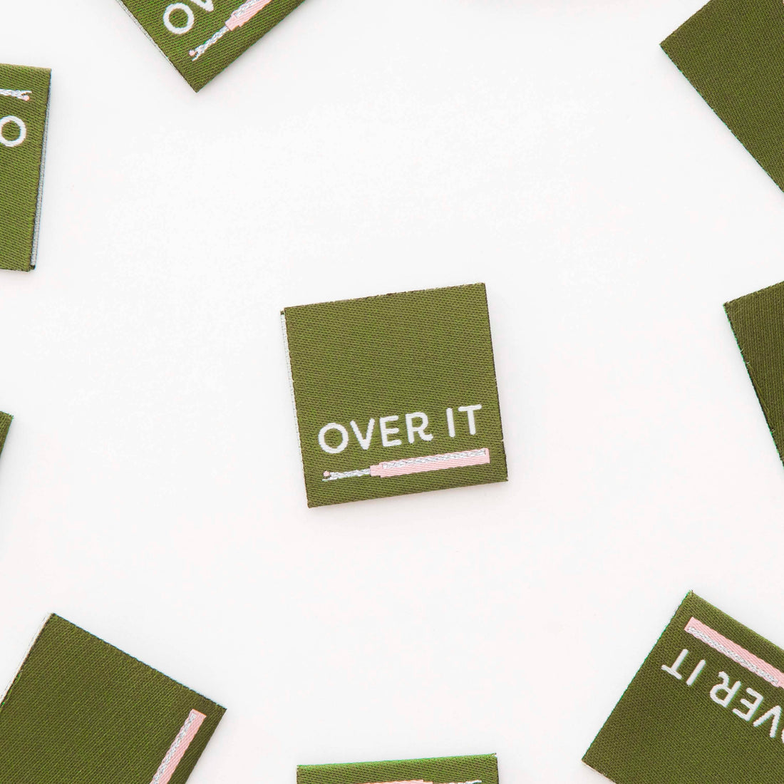 Green woven labels with &
