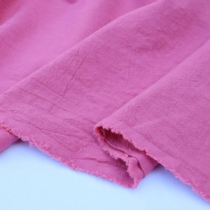 Close-up of pink fabric on a white background