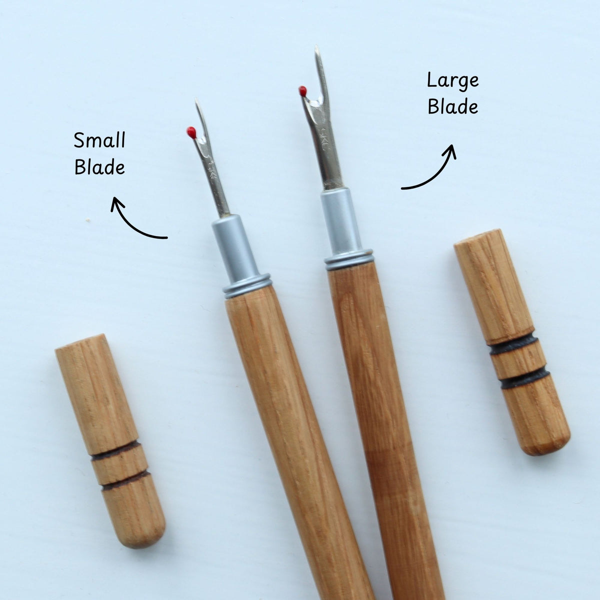 Two wooden tools with labeled blades on a white background