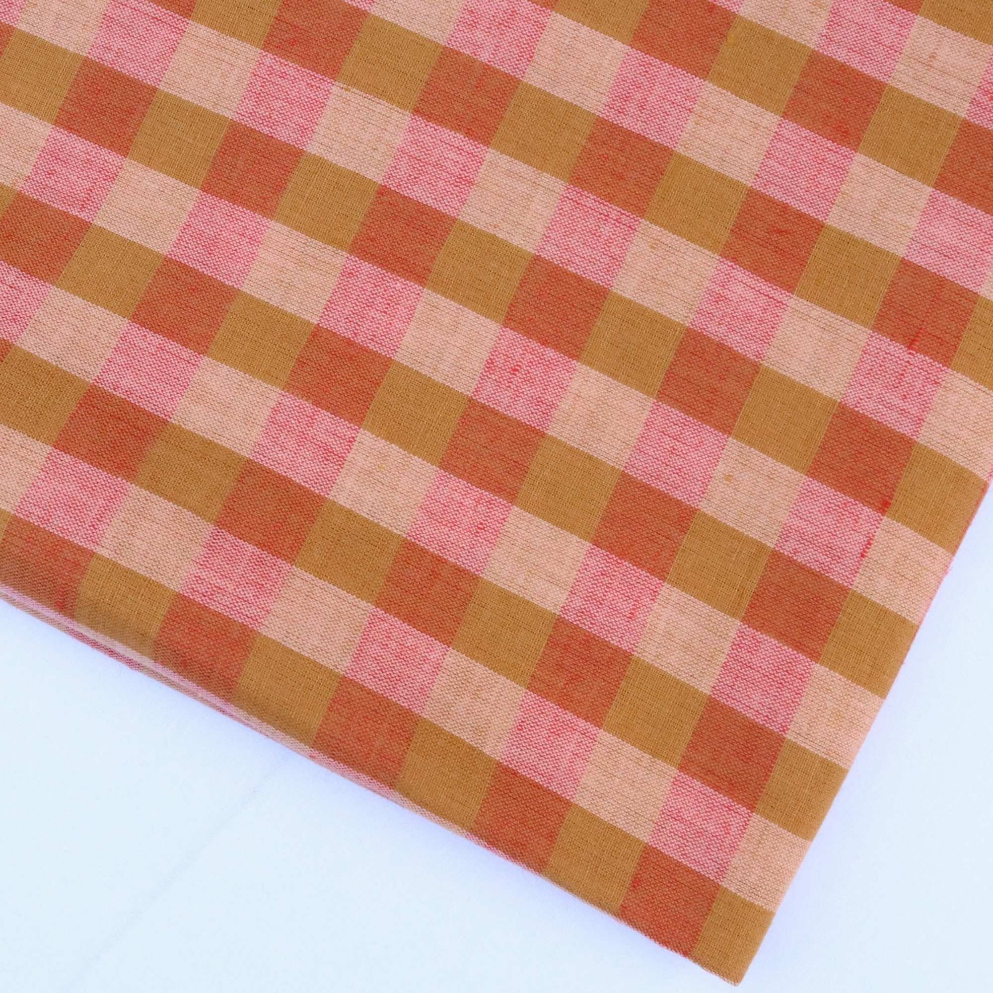 Gingham checkered fabric with light and dark orange pattern on a white background