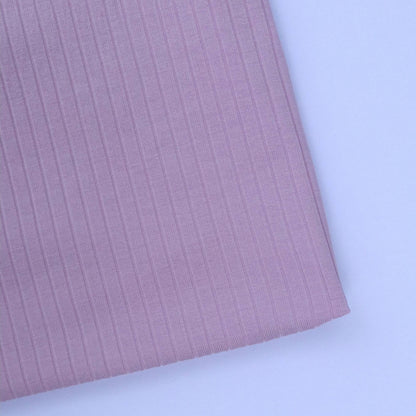Close-up of pink ribbed fabric on a white background