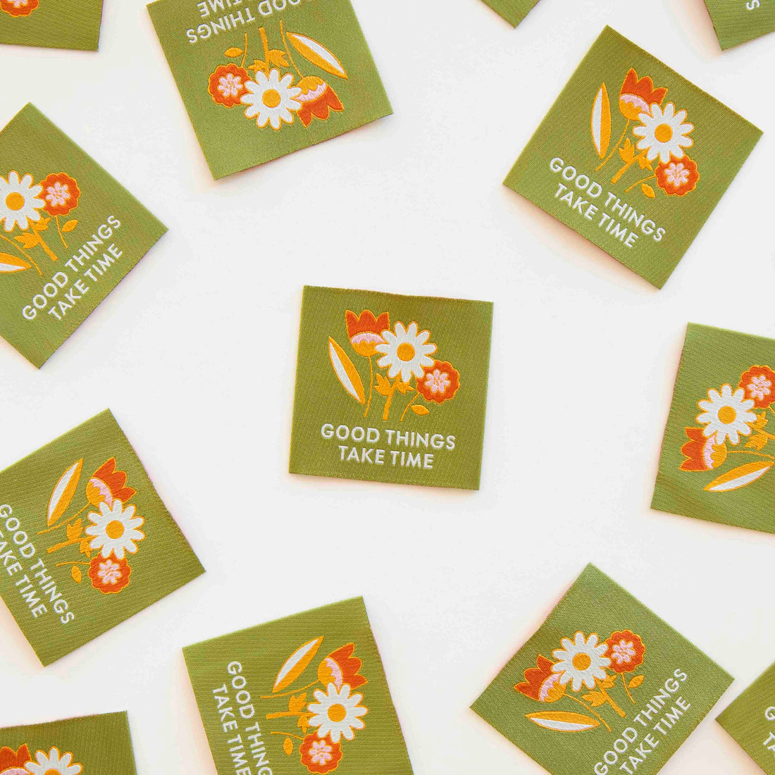 Green Labels with a floral design with the words &quot;Good Things Take Time&quot; on them. A Woven Sew in Label for your Handmade Sewing Makes.