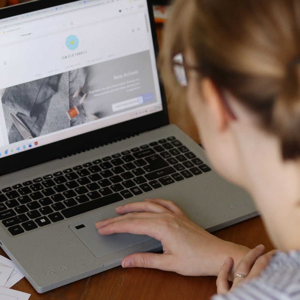 Laptop on table with white female working